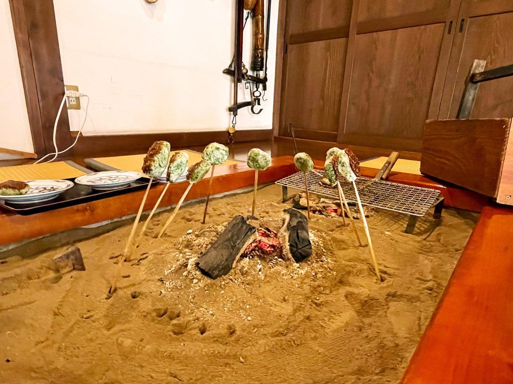 Breakfast mochi (Japanese rice cake) cooked indoors on an open fire.