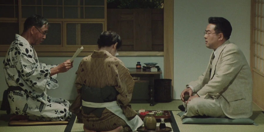 Three people sitting in silence in a Japanese-style room (from "Madadayo")