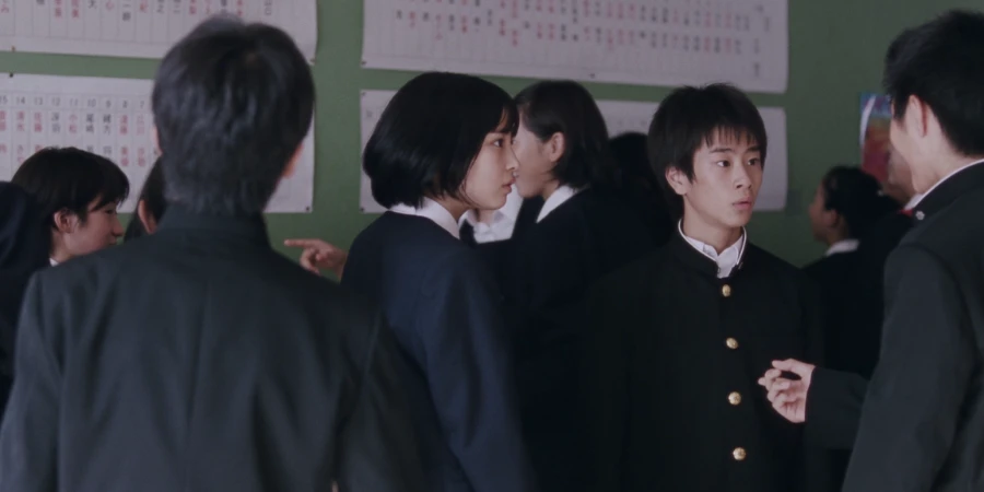 Students gathering around the test results area inside the school