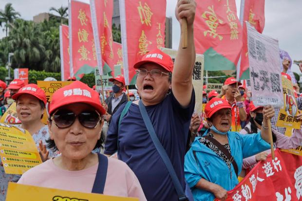 Taiwanese workers shout slogans during a May Day rally in Taipei, Taiwan