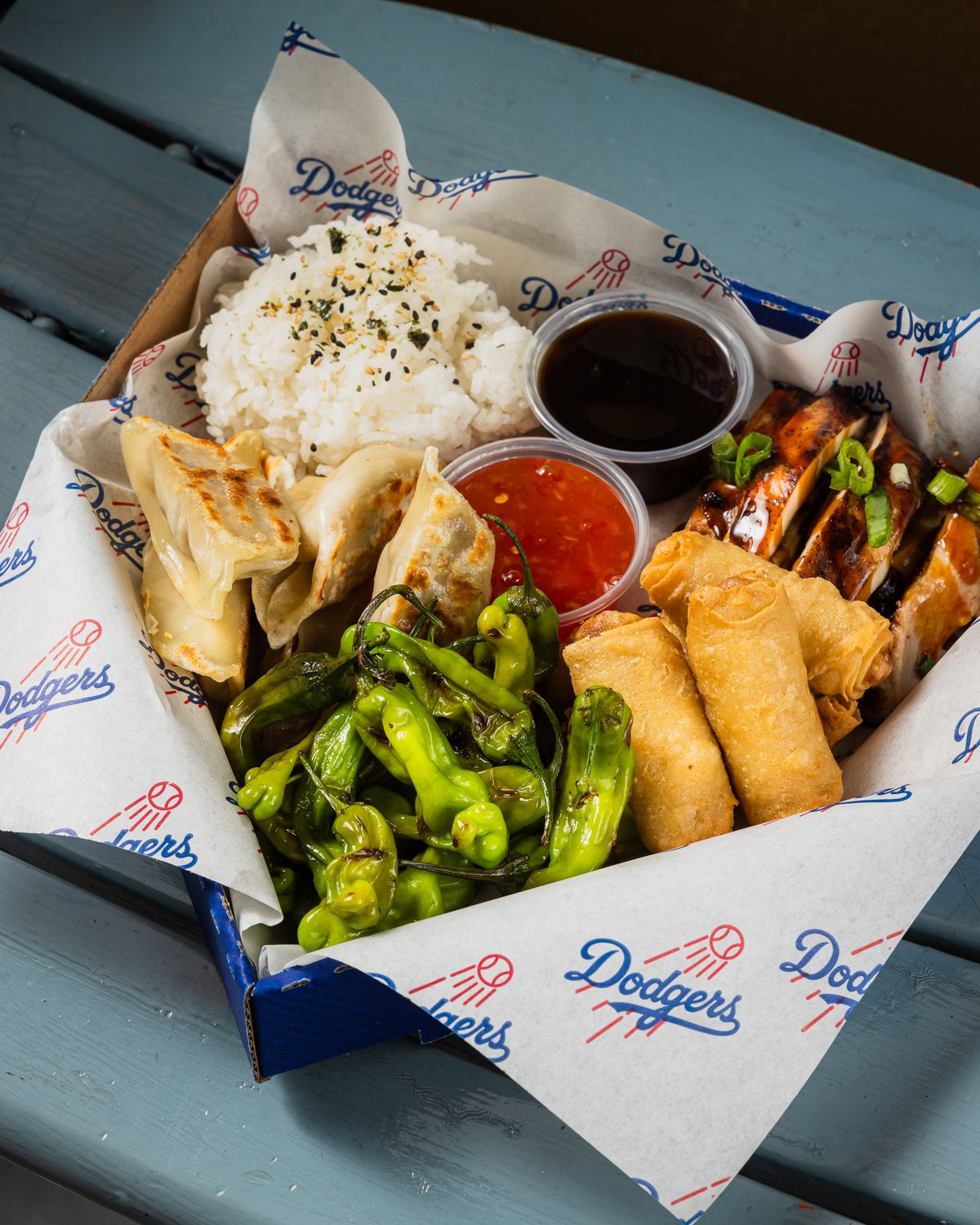 A box of Japanese dumplings, shishito peppers, and teriyaki chicken at Dodger Stadium.