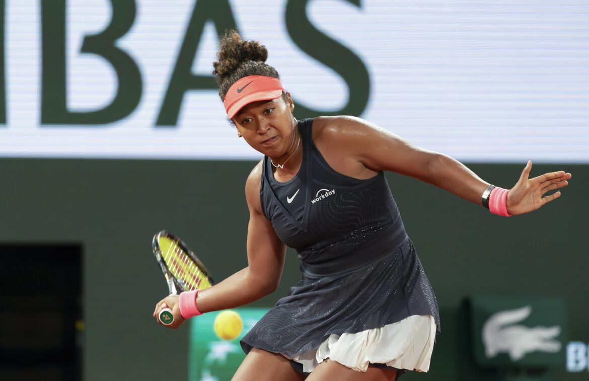 May 29, 2024; Paris, France; Naomi Osaka of Japan returns a shot during her match against Iga Świątek of Poland on day four of Roland Garros at Stade Roland Garros.