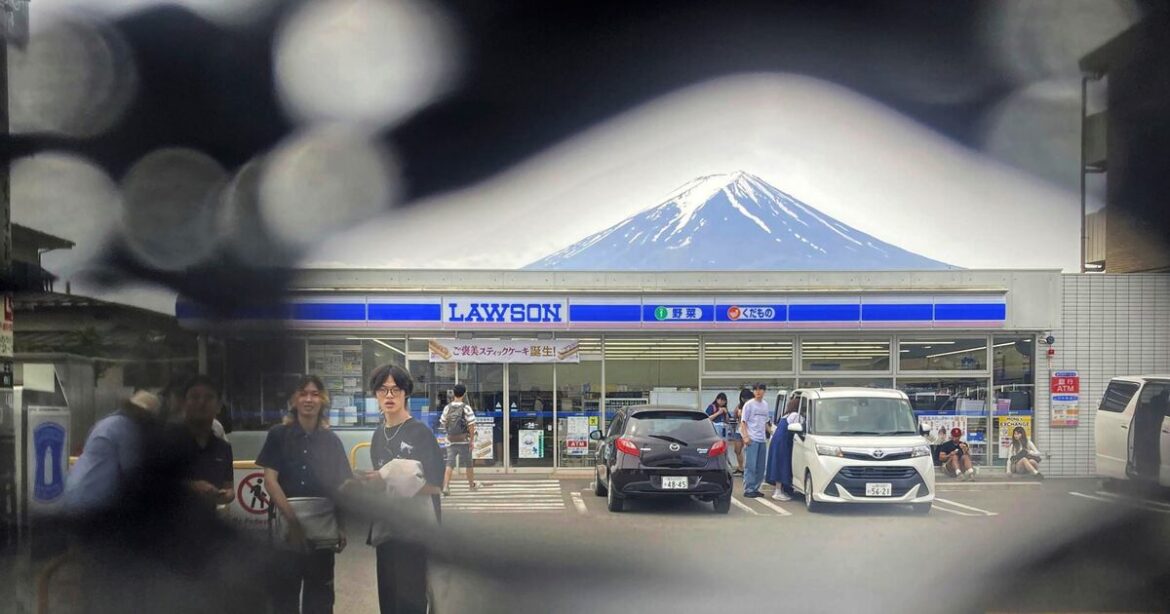 Tourists have made holes in a screen to take photos of Mount Fuji – Deseret News Tourists have made holes in a screen to take photos of Mount Fuji – Deseret News