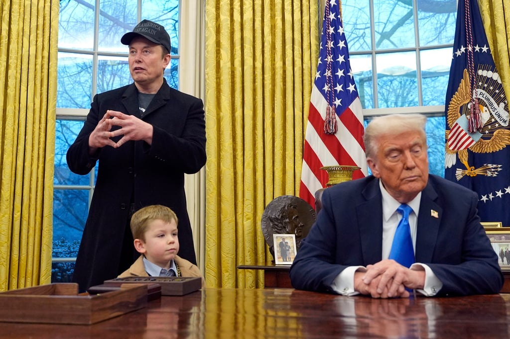 US President Donald Trump listens as Elon Musk, joined by his son X Æ A-Xii, speaks in the Oval Office at the White House on Feb. 11, 2025, in Washington. Photo: AP