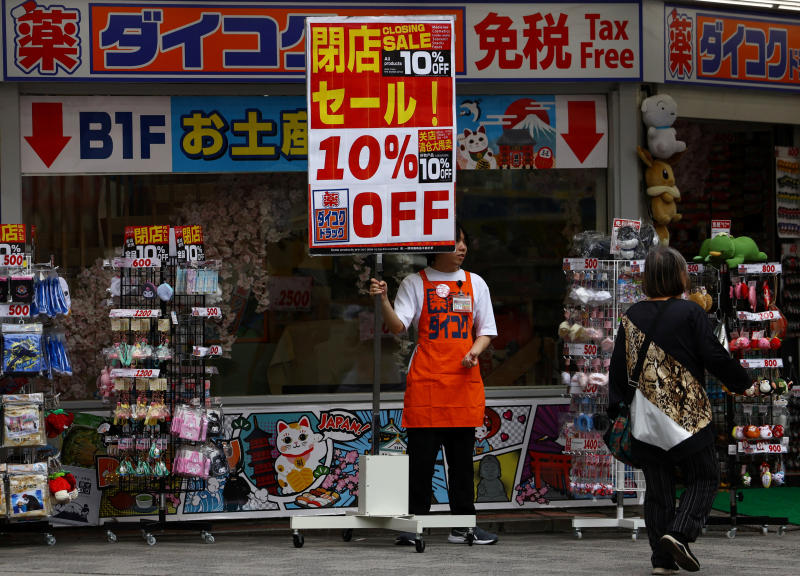 A store staff member tries to attract customers in Tokyo, Japan, on Thursday. (Photo: Reuters)
