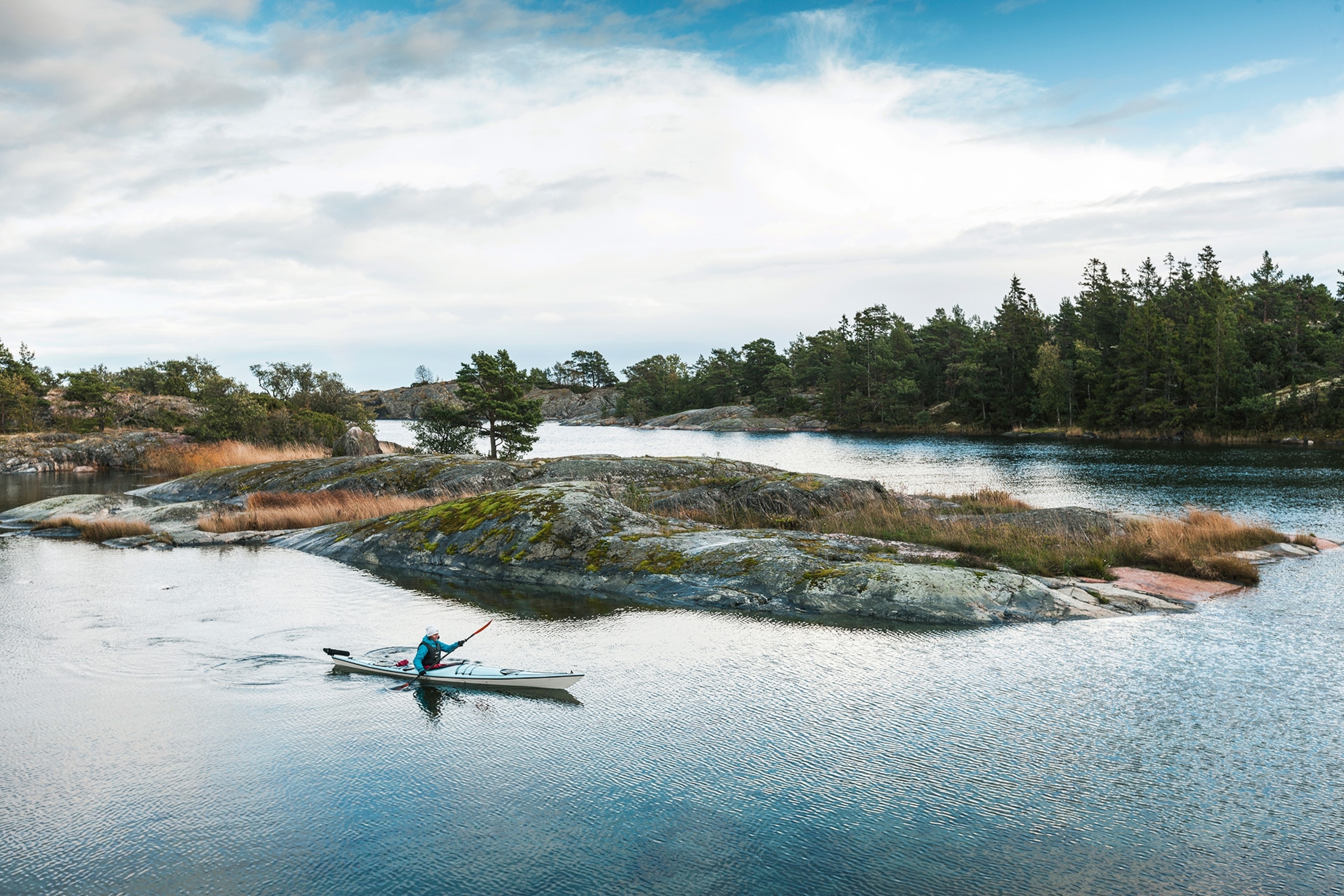 Man kayaks through the Stockholm Archipelago