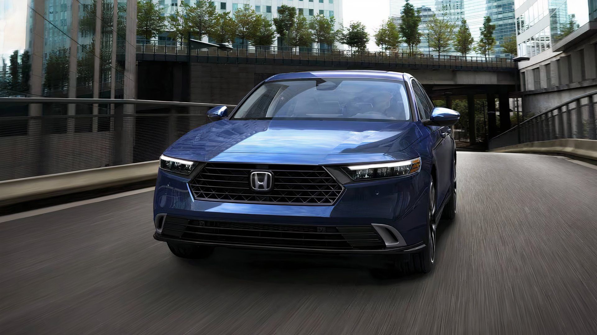 2025 Honda Accord Touring Hybrid in blue driving on road