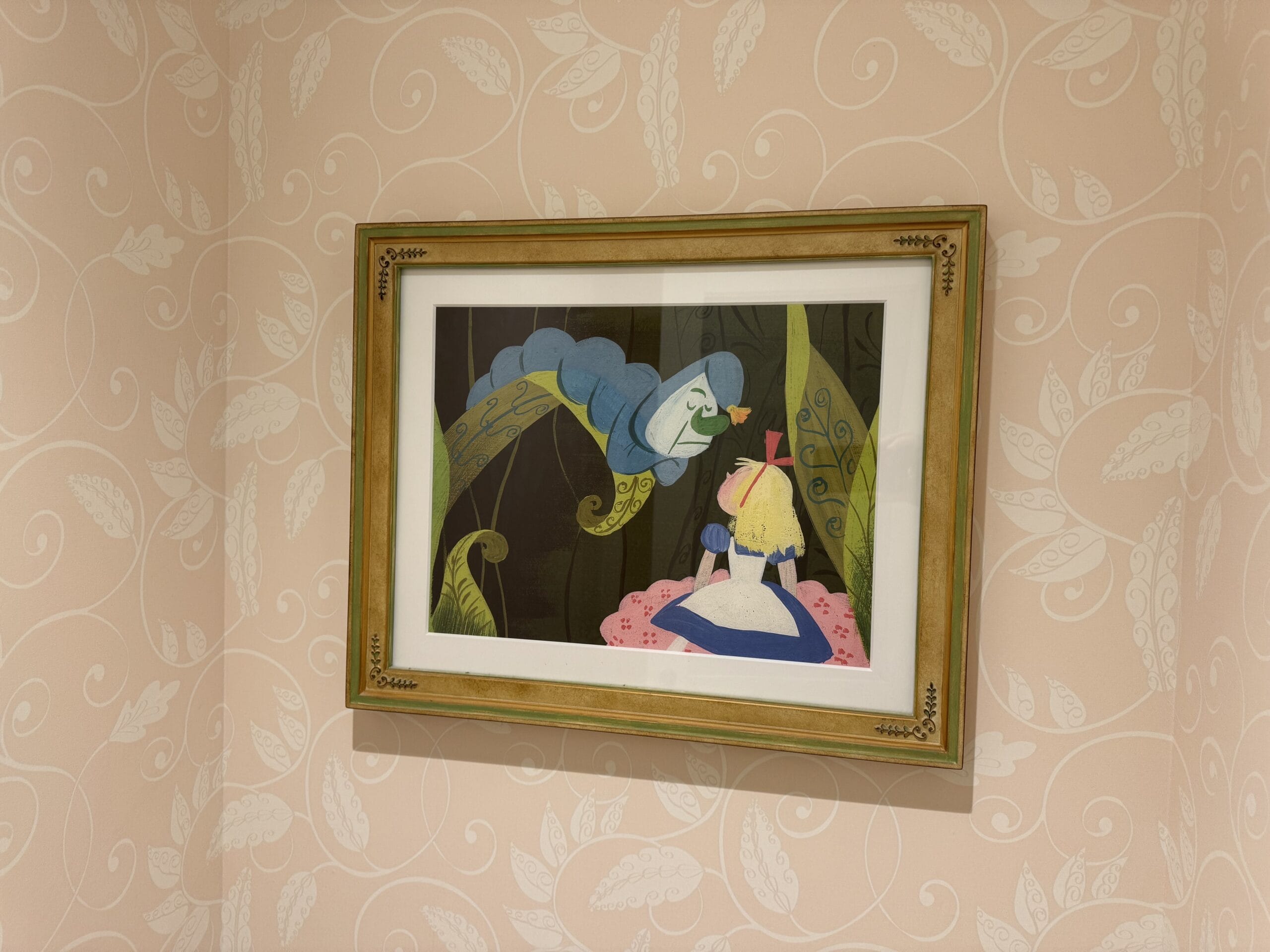 Framed Alice and blue caterpillar illustration from "Alice in Wonderland" in a Tokyo Disneyland Hotel room.