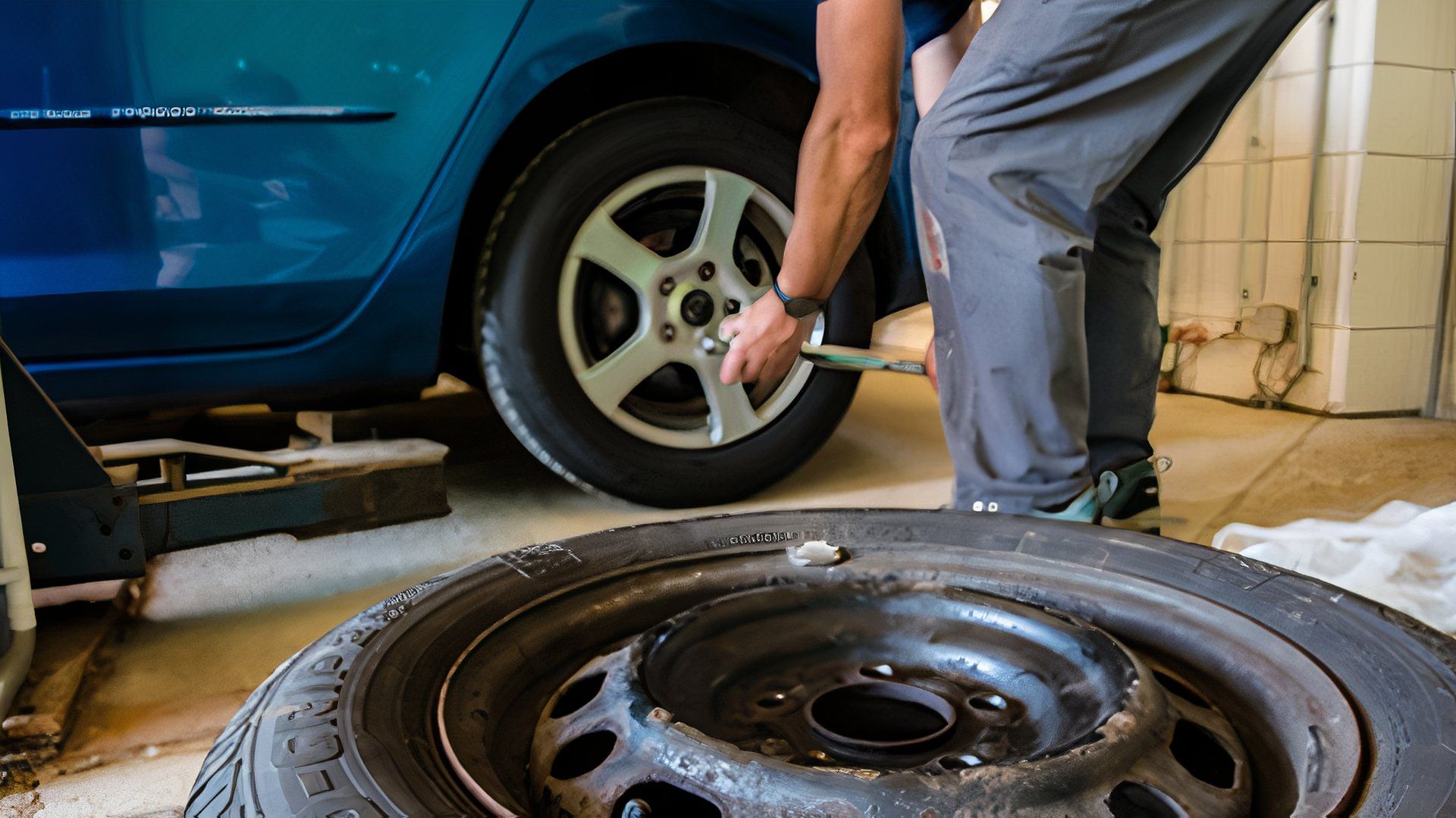 A tire shop mechanic changes a tire
