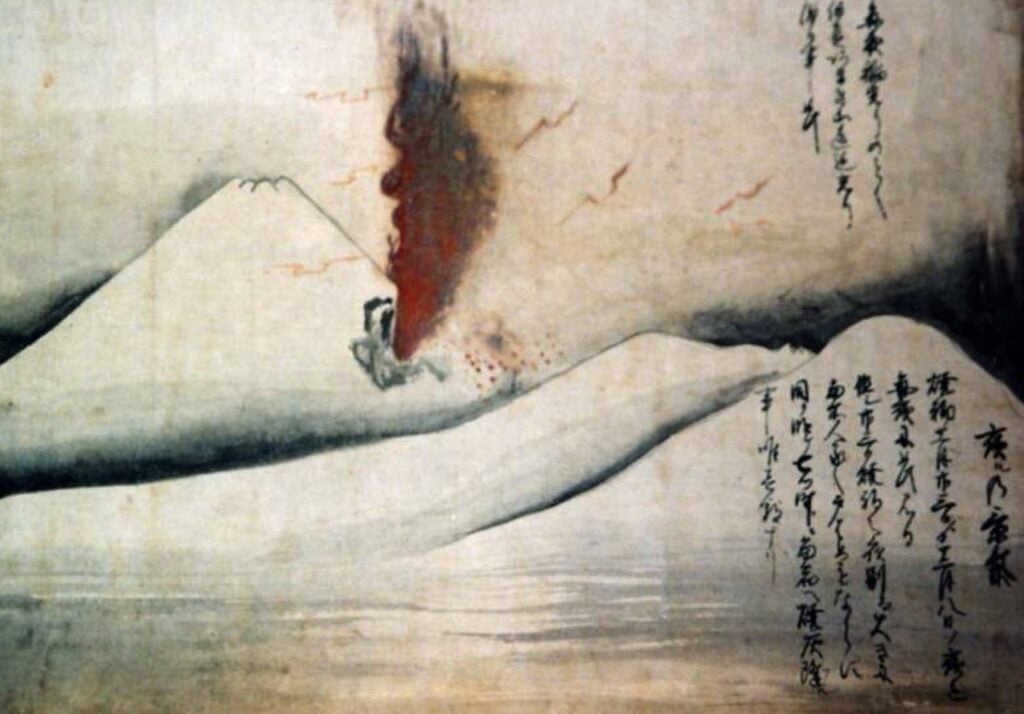 A woodblock print show red and black smoke emitting from Mt. Fuji's conical shape during the 1707 Hoei Eruption.