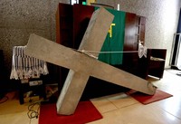 The cross that once adorned the top of the old chapel of Shuri Church is seen inside the church in Naha, May 21, 2025. After surviving the flames of war with some damage, it was repaired and used at the church. Following the demolition of the old chapel in 1984, it is now stored inside the church. (Mainichi/Shinnosuke Kyan)