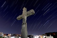 The cross of Shuri Church, which was restored in 2017, is pictured in this composite image made from 100 photos captured over 54 minutes in Naha on May 3, 2025. The restoration replicated its condition at the time of the Battle of Okinawa, when it was severely damaged. (Mainichi/Shinnosuke Kyan) 