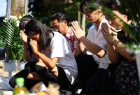 People put their hands together to pray in front of the Konpaku-no-to Monument in Itoman, Okinawa Prefecture, on Okinawa Memorial Day, June 23, 2025. (Mainichi/Tatsuro Tamaki)