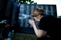 Hideko Kinjo, 79, joins her hands together to pray in front of her father Seiichi Sueyoshi's inscribed name in Itoman, Okinawa Prefecture, on Okinawa Memorial Day, June 23, 2025. Since Hideko was in her mother's womb at the time, she says, 