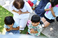 A family of three generations commemorates relatives who died in war, at the Cornerstone of Peace monument in Itoman, Okinawa Prefecture, on Okinawa Memorial Day, June 23, 2025. (Mainichi/Tatsuro Tamaki)