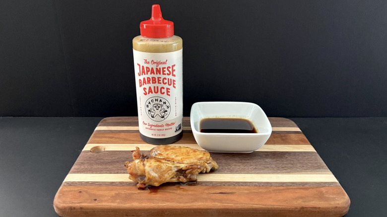 Bachan's The Original Japanese Barbecue Sauce on wooden cutting board with wings and ramekin