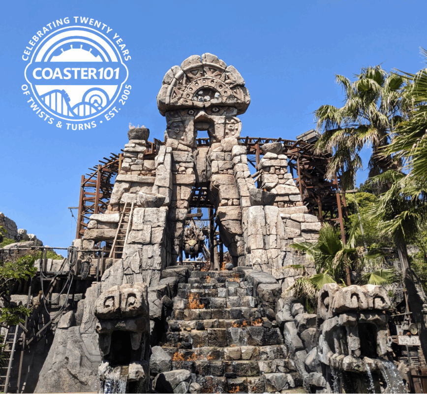 Fake temple front of the Raging Spirits roller coaster at Tokyo DisneySea, with the Coaster101 20th anniversary logo in the top right corner.