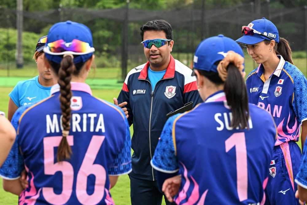 This photo taken on June 4, 2025 shows Japan national women's cricket team head coach Iyer Vinay from India (centre) speaking to the team prior to the women's Sano City International Trophy cricket match between Japan and Hong Kong in Sano, Tochigi prefecture. — AFP pic