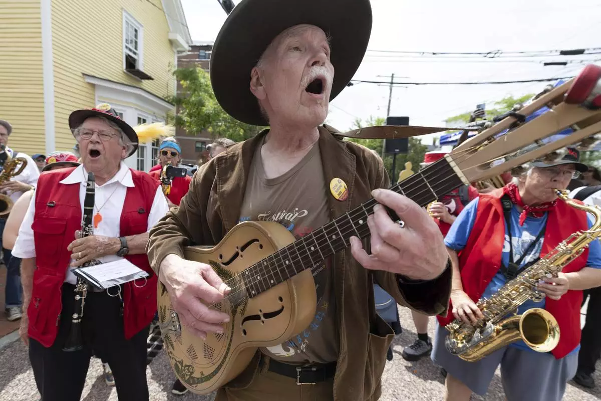 T.J. Wheeler sings along with the Leftist Marching Band during a Juneteenth celebration at the African Burying Ground Memorial Park Thursday, June 19, 2025, in Portsmouth, N.H. (AP Photo/Michael Dwyer)