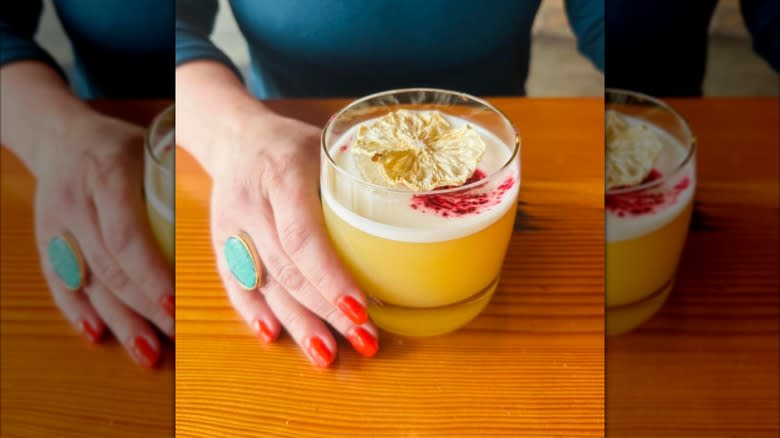 A hand holds a Japanese sour cocktail