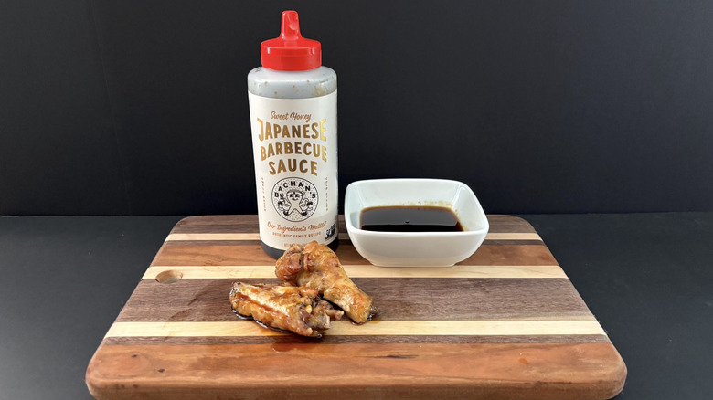 Bachan's Sweet Honey Japanese Barbecue Sauce on wooden cutting board with wings and ramekin