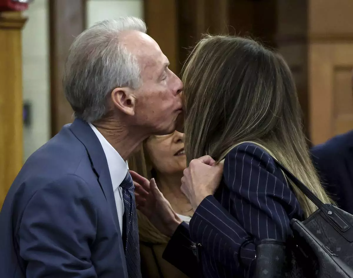 William Read kisses his daughter, Karen Read, before the start of her murder trial in Norfolk Superior Court in Dedham, Mass., Friday, May 30, 2025. (Mark Stockwell/The Sun Chronicle via AP, Pool)