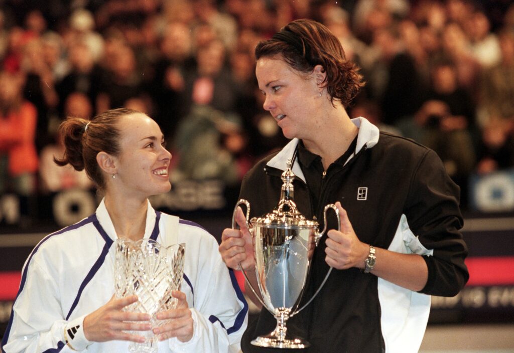 Lindsay Davenport and Martina Hingis of Switzerland smile and hold up their trophies after the Chase Championships at Madison Square Garden in New York.