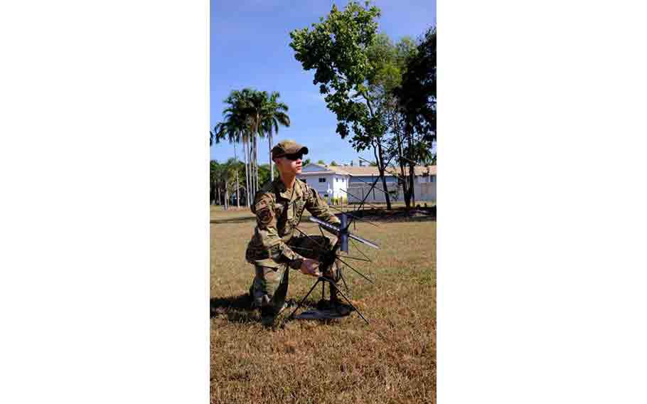 U.S. Air Force Senior Airman Christopher Koon, 18th Communications Squadron expeditionary communications technician, sets up radio communications during exercise RECCE-Edge 25 at Royal Australian Air Force Base Darwin, Australia.