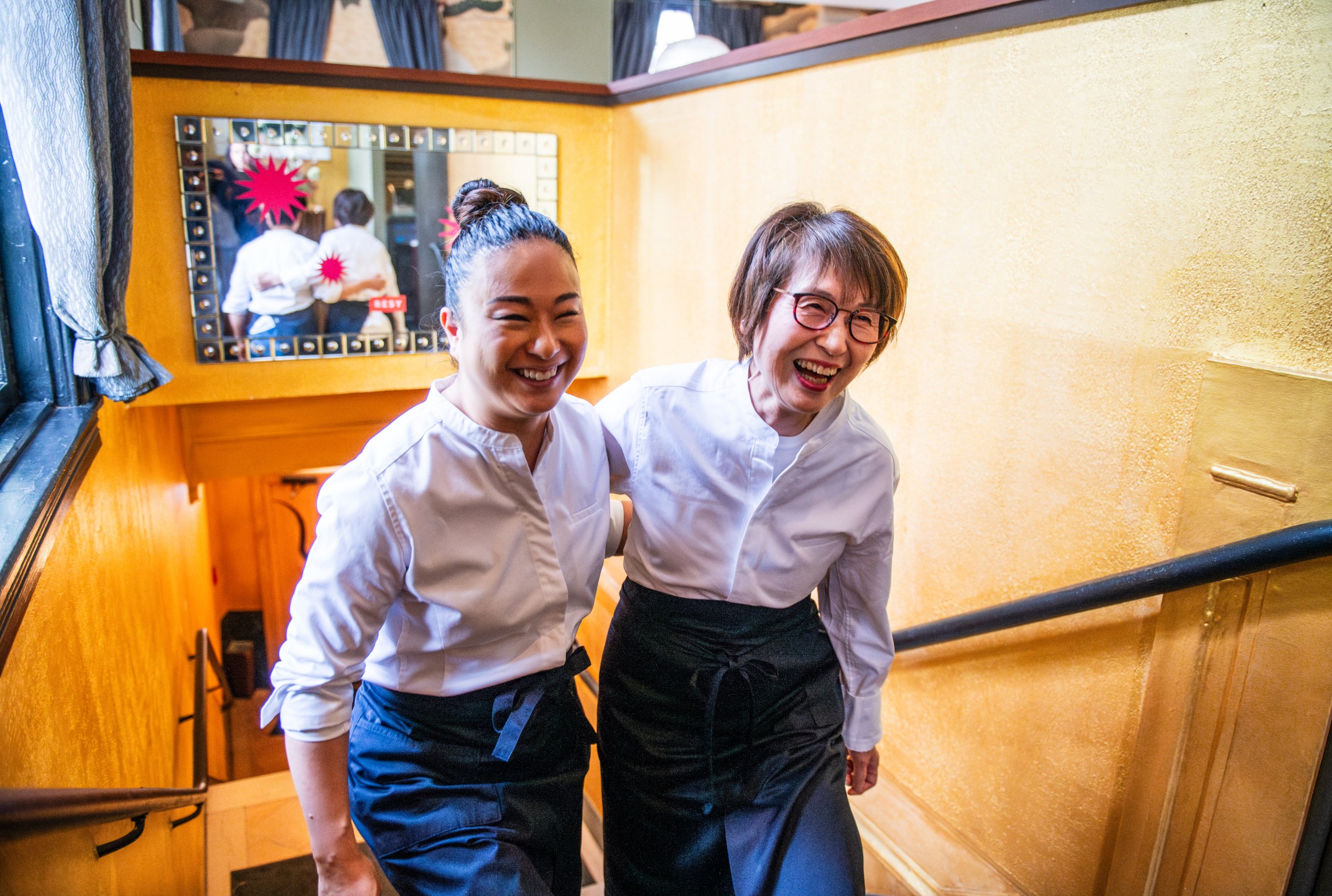 Masako and Ryoko Morishita climb the stairs at Perry’s with their arms around each other and smiling.