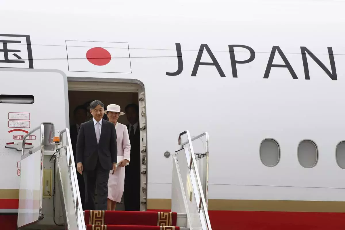 Japanese Emperor Naruhito, left and Empress Masako arrive at the Chinggis Khaan International Airport near Ulaanbaatar, Mongolia on Sunday, July 6, 2025. (MONTSAME News Agency via AP)