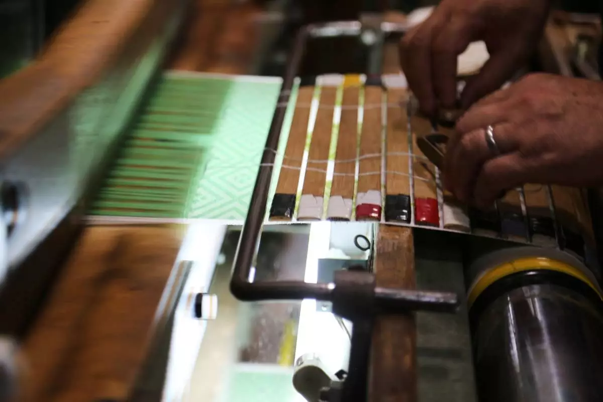 Hironori Fukuoka, the fourth-generation successor to his Nishijinori business, works on the fabric that is a collaboration with AI in Kyoto, western Japan on July 3, 2025. (AP Photo/Yuri Kageyama)