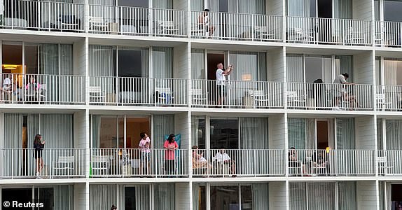 Vacationers stand on balconies at the 'Alohilani Resort looking towards Waikiki Beach after authorities warned of the possibility of tsunami waves, following an earthquake which earlier struck off Russia's Far Eastern Kamchatka Peninsula, in Honolulu, Hawaii, U.S. July 29, 2025. REUTERS/Nicola Groom TPX IMAGES OF THE DAY