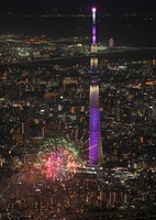 Fireworks are displayed during the Sumida River Fireworks Festival in Tokyo on July 26, 2025, in this photo taken from a Mainichi Shimbun helicopter, with Tokyo Skytree illuminated in purple. (Mainichi/Koichiro Tezuka) 