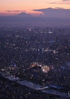 Fireworks are set off as dusk falls over Tokyo during the Sumida River Fireworks Festival on July 26, 2025, in this photo taken from a Mainichi Shimbun helicopter. Mount Fuji is seen far in the background. (Mainichi/Koichiro Tezuka)