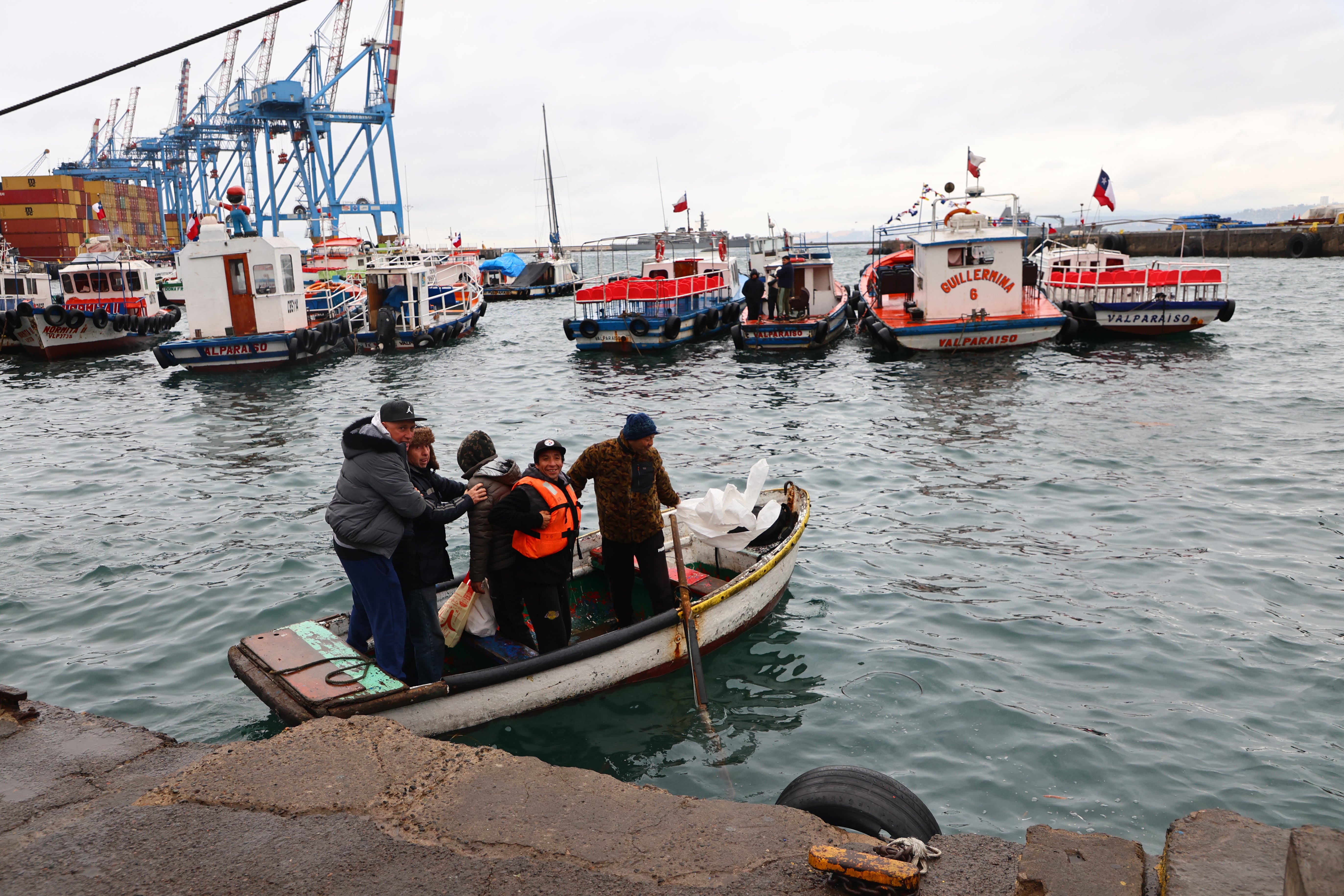 Fishermen secure their boats in the port during an evacuation plan due to a tsunami alert on July 30, 2025 in Valparaiso, Chile