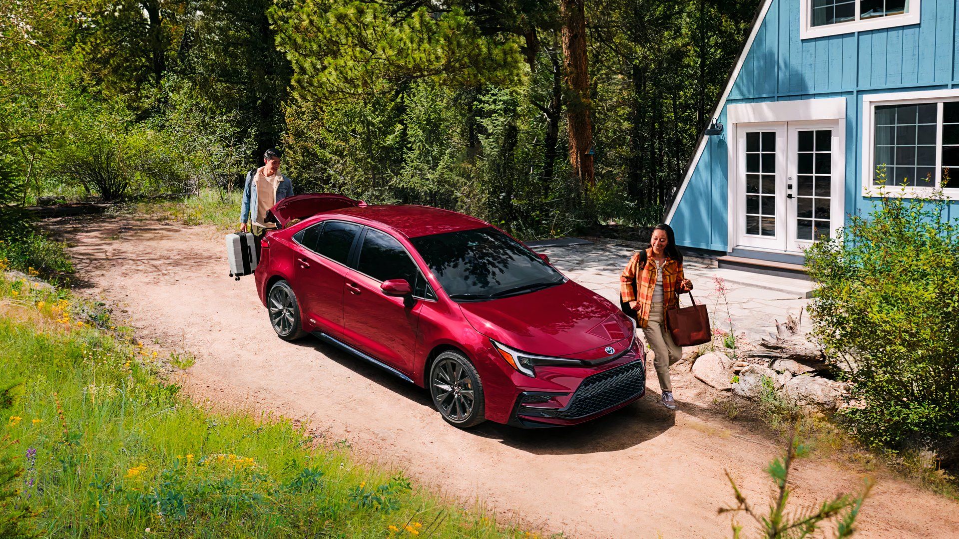A red 2025 Toyota Corolla Hybrid is parked. 