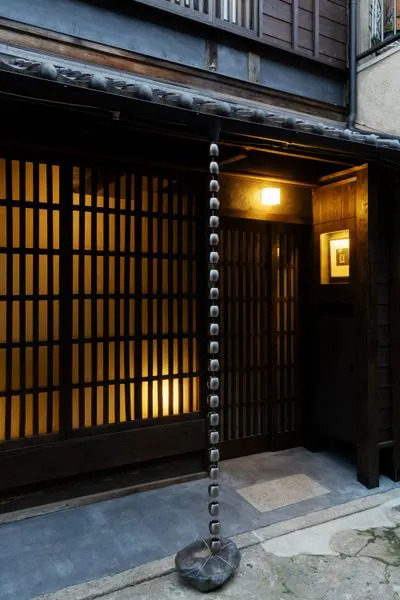 Outside, a contemporary rain chain from Seo is anchored by a stone wrapped in metal rope. 