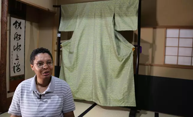 Lana Sinapayen, associated researcher at Sony Computer Science Laboratories, speaks with The Associated Press about the Nishijinori AI project with the fabric in the background in Kyoto, western Japan on July 3, 2025. (AP Photo/Yuri Kageyama)
