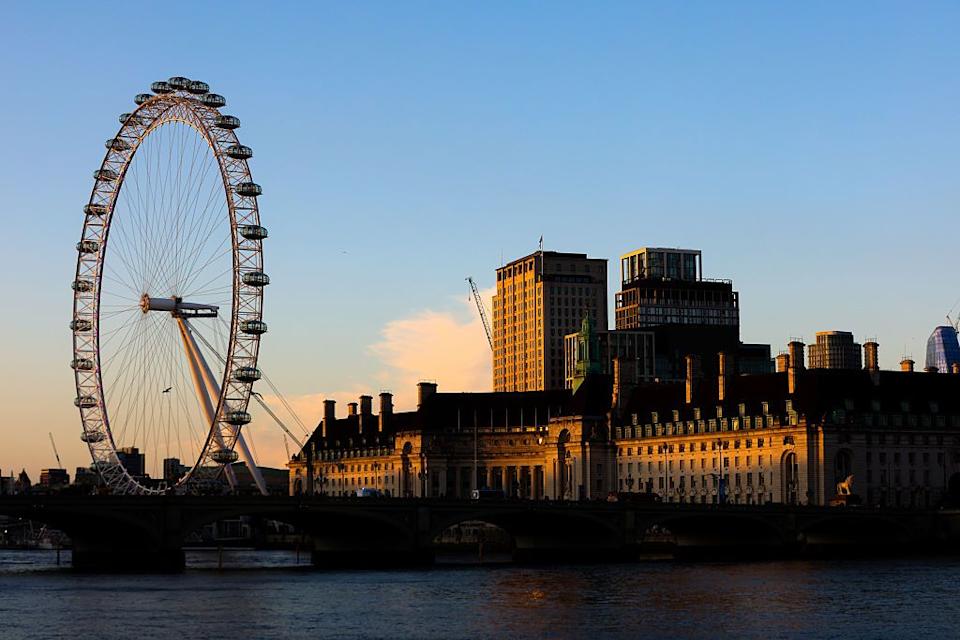 general view of london eye and london county hall during sunset.