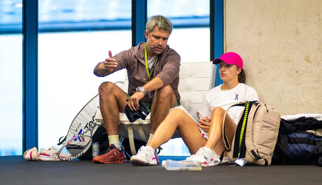 Iga Swiatek of Poland talks to coach Tomasz Wiktorowski before playing against Beatriz Haddad Maia of Brazil in the quarter-final on Day Eight of the Mutua Madrid Open at La Caja Magica on April 30, 2024 in Madrid, Spain