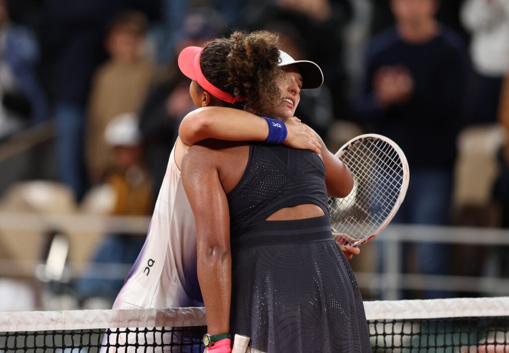 Iga Swiatek of Poland hugs Naomi Osaka of Japan after her victory in the Women's Singles second round match during Day Four of the 2024 French Open at Roland Garros.
