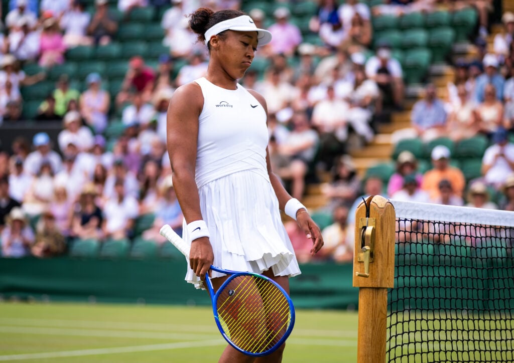 Naomi Osaka standing by the net after a point finished in the third round at Wimbledon