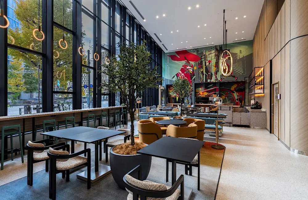 A lifestyle-first lobby designed for both social connection and solo recharging—complete with Tokyo street views.