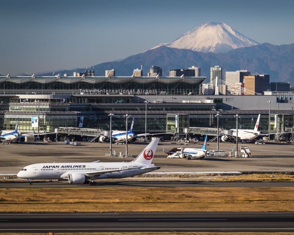 Planes land at Narita Airport Mt Fuji In Background