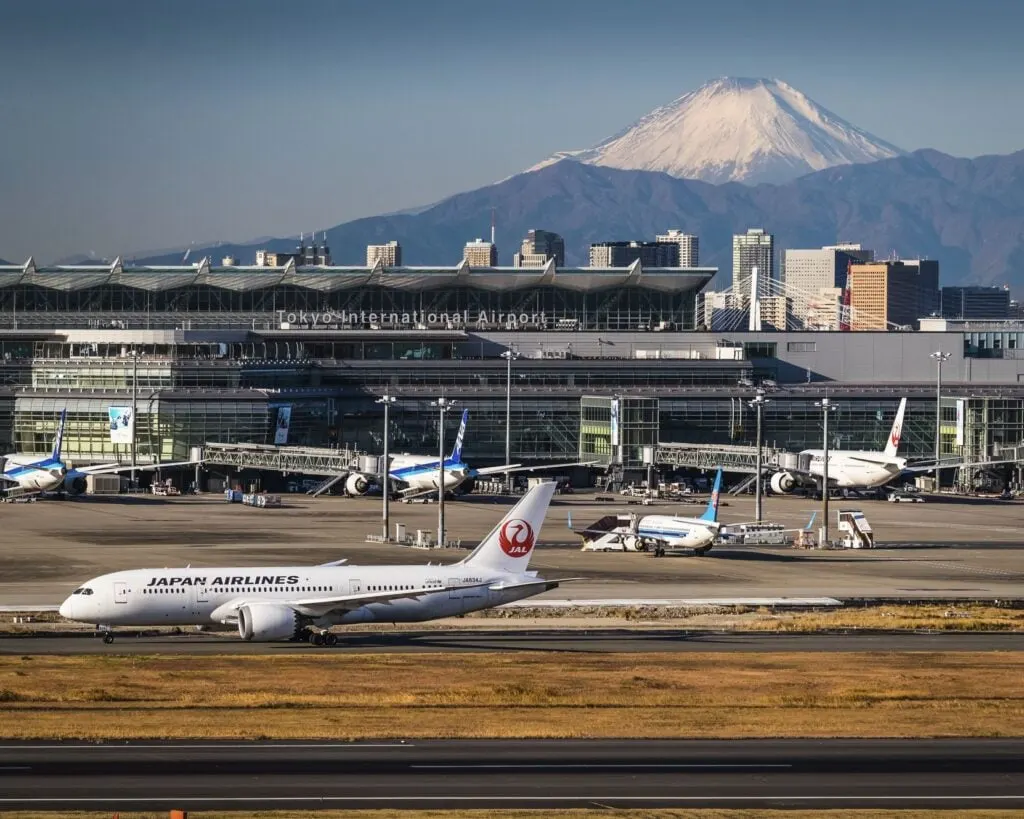 Planes land at Narita Airport Mt Fuji In Background