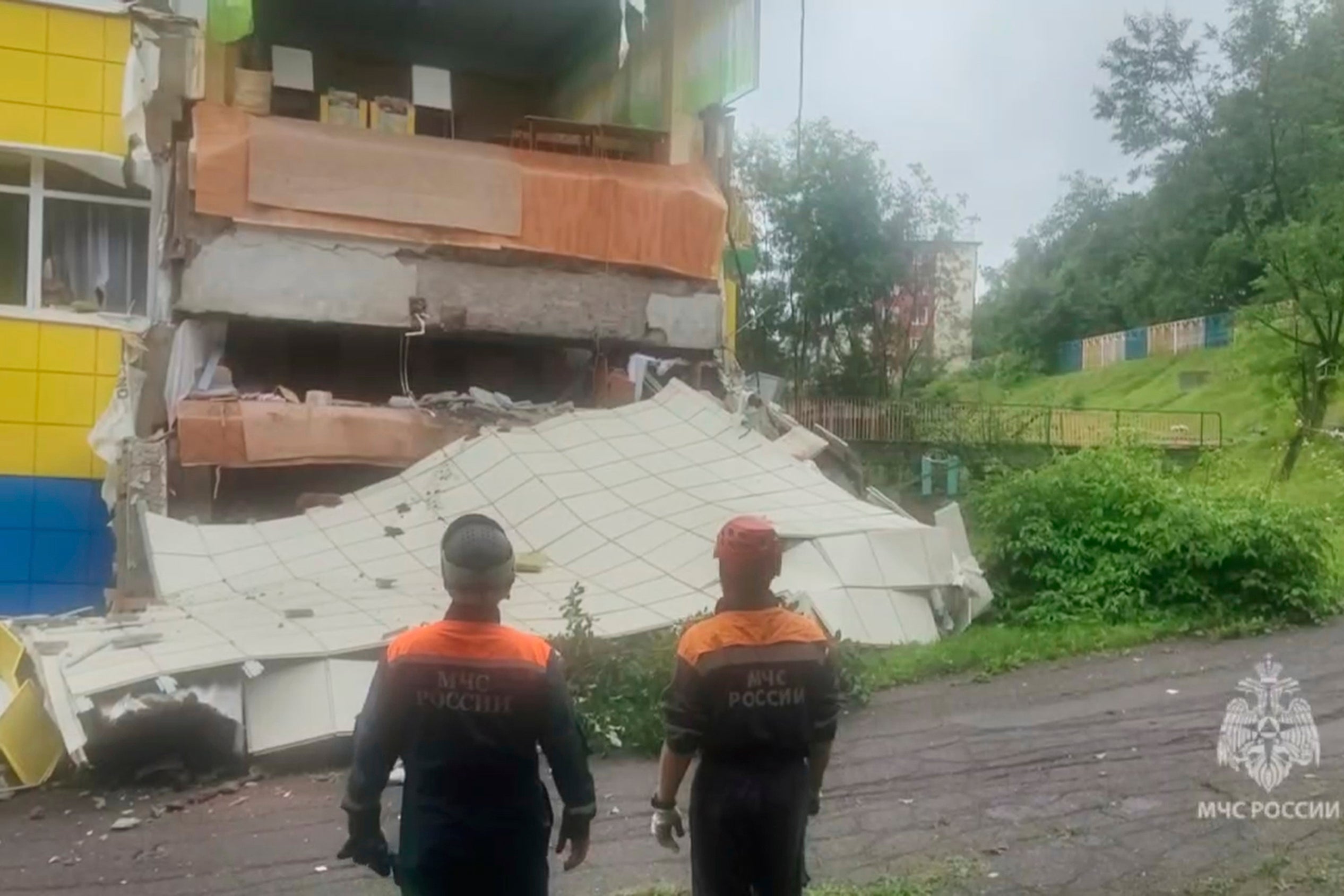 Emergency services personnel inspect a kindergarten damaged by the earthquake in Petropavlovsk-Kamchatsky, Russia, on Wednesday