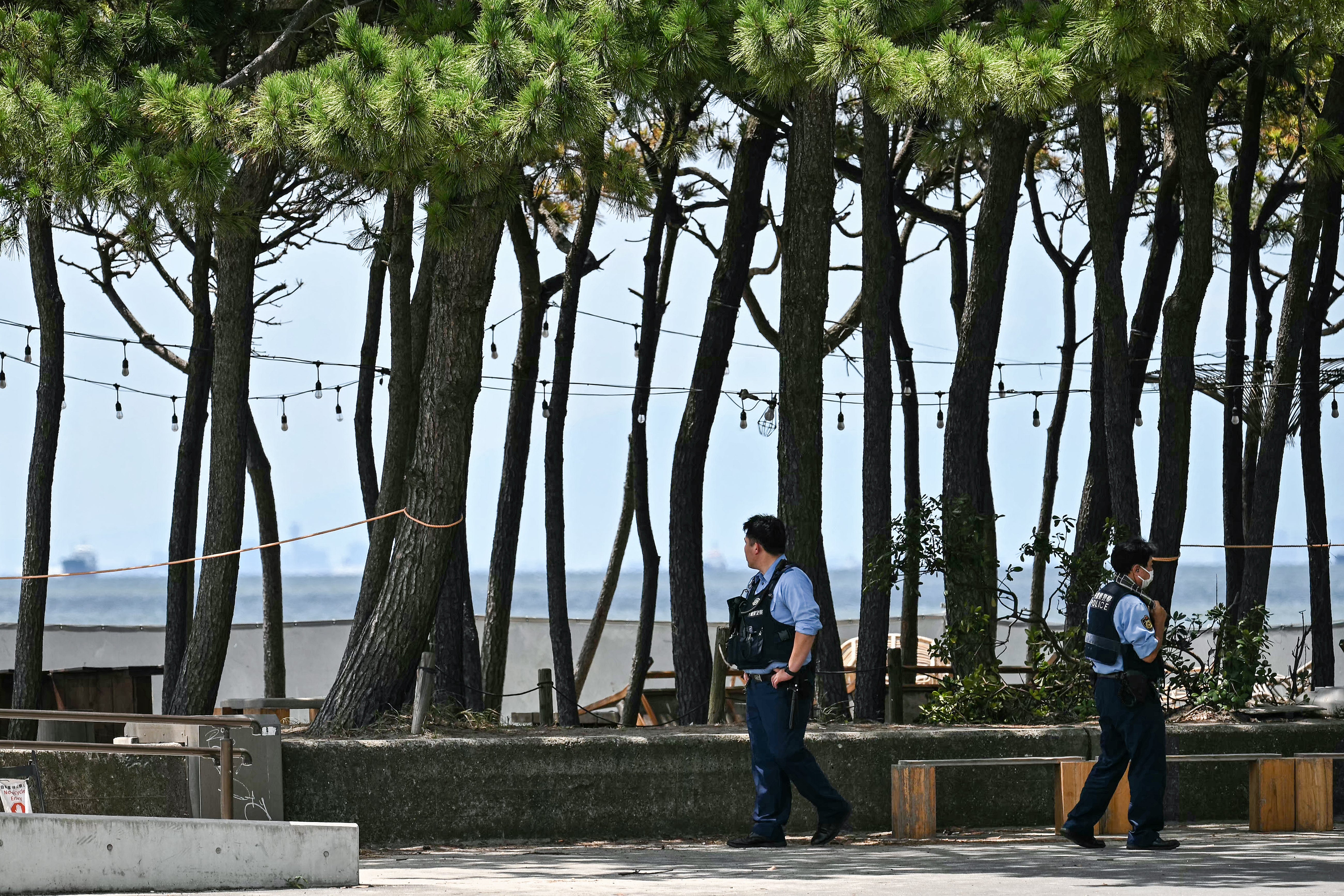 Members of the police patrol along the coast after people were advised to leave coastal regions as much of coastal Japan went on alert