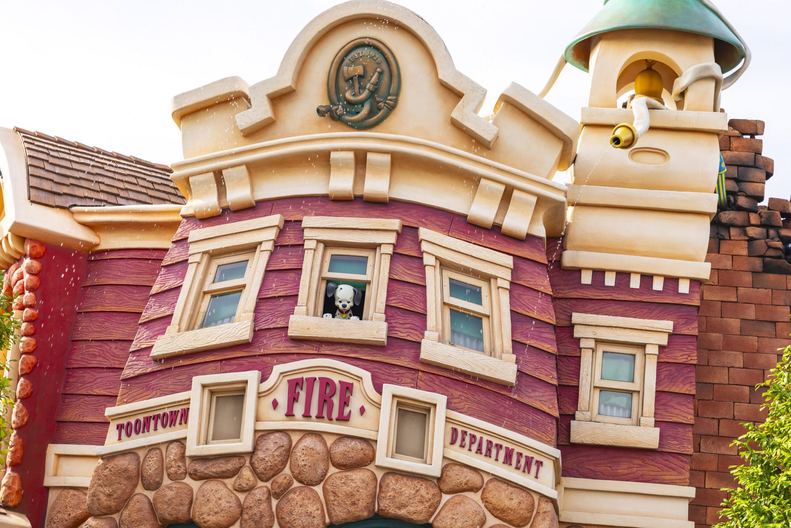 Cartoon-style fire department building with a skeleton peeking out of an upstairs window.