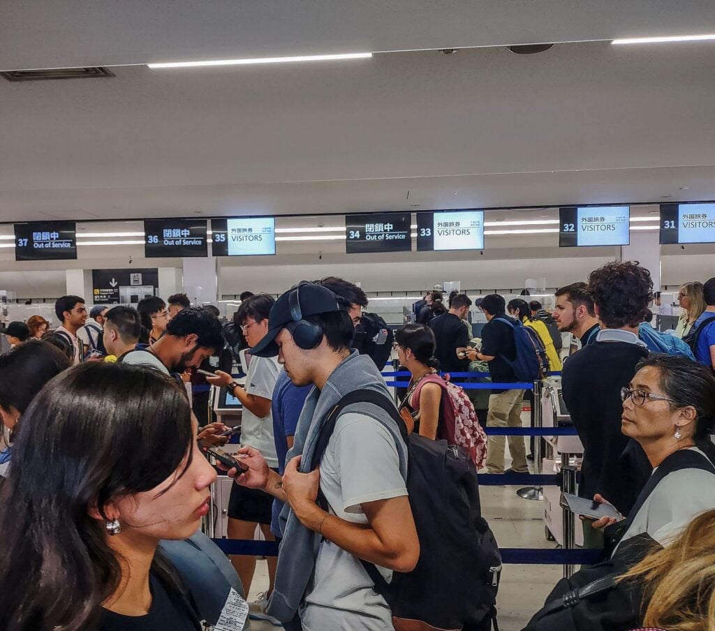 Travelers Wait in line at Narita airport for border control