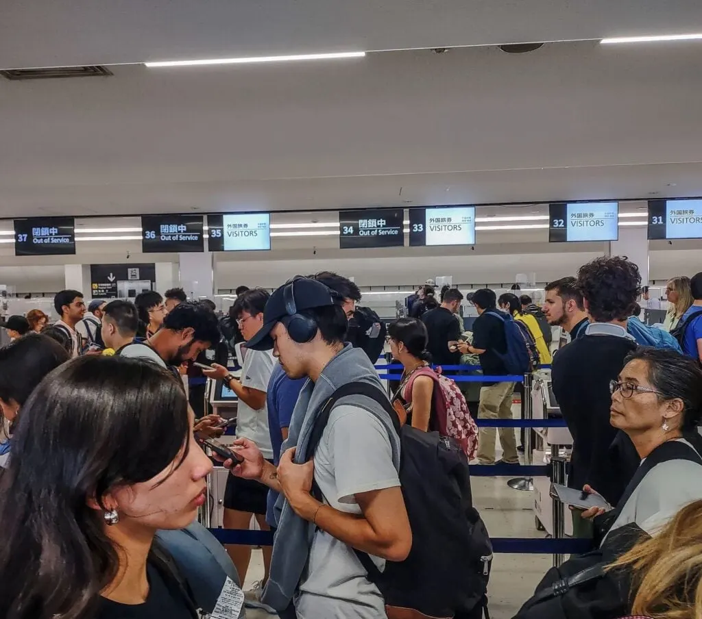 Travelers Wait in line at Narita airport for border control